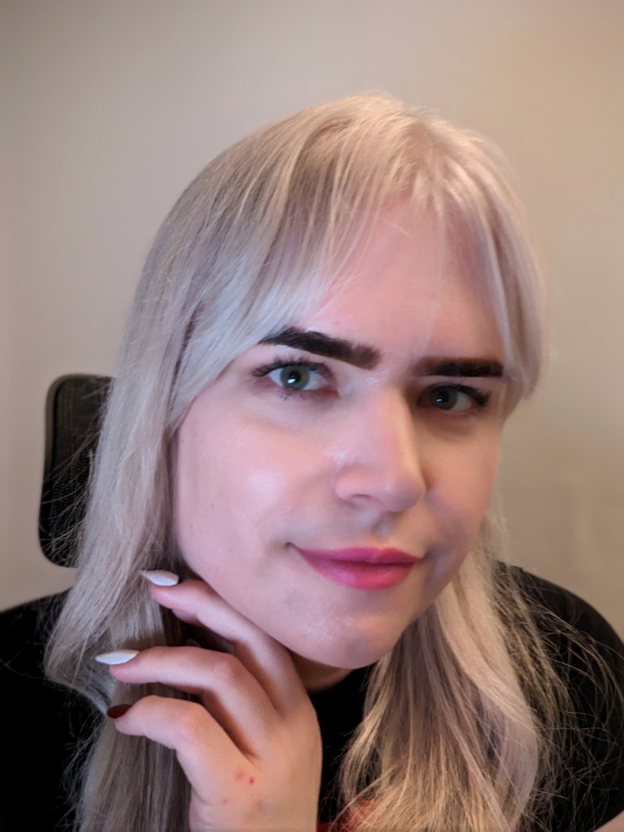 Photo of me with freshly-bleached hair, very bold eyebrows, and fancy nails.